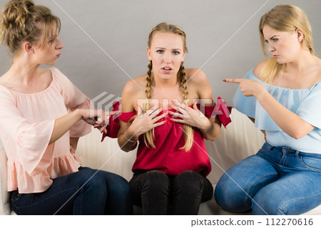 Woman being bullied by two females Woman being bullied by two females 112270616