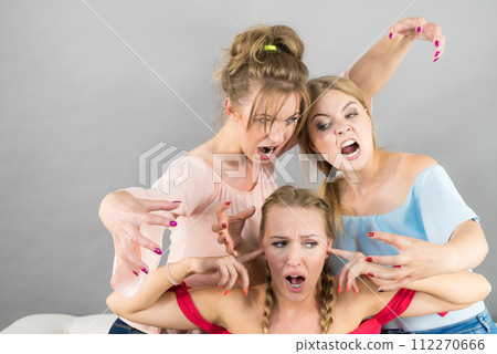 Woman being bullied by two females Woman being bullied by two females 112270666