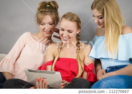 Three women using tablet Three women using tablet 112270667