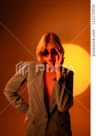 Fashionable portrait of blonde lady in sunglasses posing.  112270856