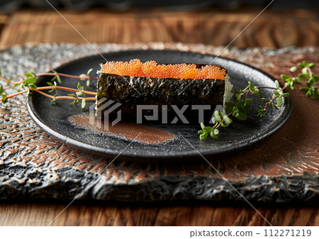 Japanese cuisine sushi on a black plate, set on a table 112271219