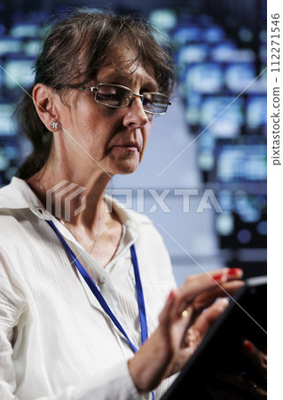 Seasoned wireman preparing cloud computing business recovery plan, monitoring data center energy consumption across parts, making sure sensors are in ideal condition, doing annual disk checks Seasoned wireman preparing cloud computing business recovery plan, monitoring data center energy consumption across parts, making sure sensors are in ideal condition, doing annual disk checks 112271546