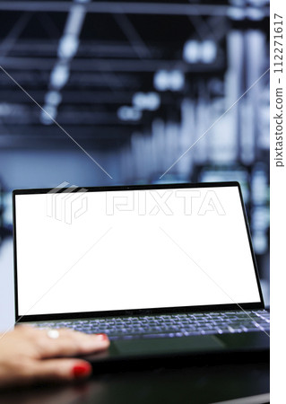 Close up shot of mock up laptop used by admin in server room delivering massive computing power, capable of processing and storing vast amounts of data and controlling network resources 112271617