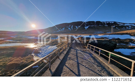 Freezing cold icelandic landscape, roadside setting with path for sightseeing, creating wintry scenery in iceland. Frosty natural scandinavian panoramic view. 112271652