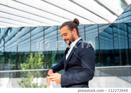 Businessman standing outdoor use smartphone Businessman standing outdoor use smartphone 112272648