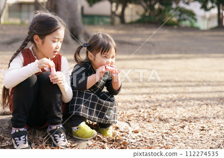 Girls playing with soap bubbles 112274535