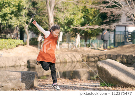 Girls playing in the park Girls playing in the park 112275477