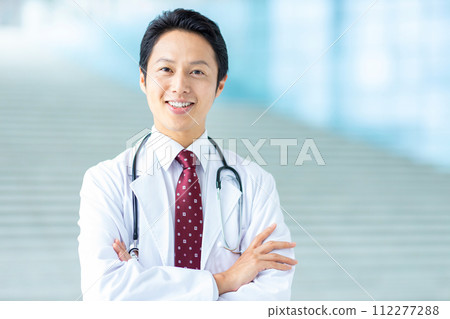 Male doctor wearing white coat Male doctor wearing white coat 112277288