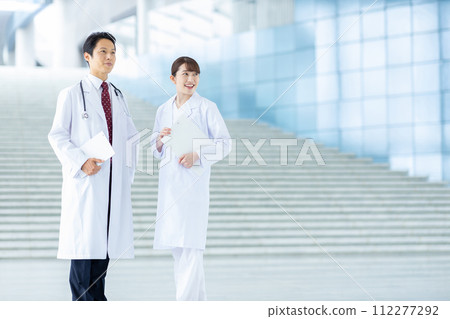 Male and female doctors at university hospital Male and female doctors at university hospital 112277292