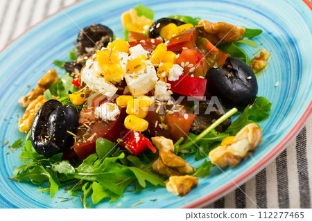 Salad with arugula, olives, Feta cheese, corn and walnut is tasty dish Salad with arugula, olives, Feta cheese, corn and walnut is tasty dish 112277465