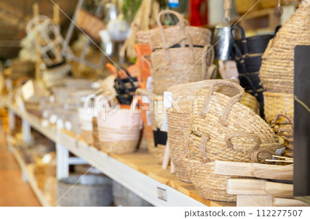 Wicker baskets and other handmade items on store shelves close up Wicker baskets and other handmade items on store shelves close up 112277507