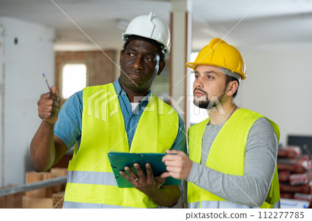 Two engineers discussing work in apartment Two engineers discussing work in apartment 112277785