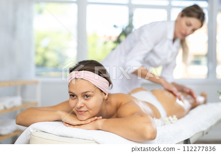 Young woman gets massage of her thighs and buttocks Young woman gets massage of her thighs and buttocks 112277836