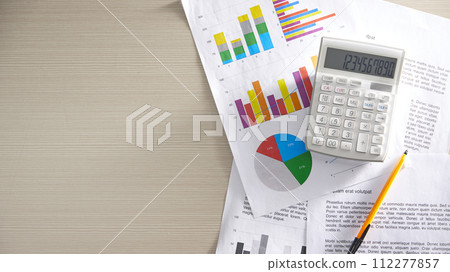 Desk with calculators for calculating, managing and analyzing economic profits and losses. 112277857