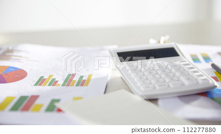 Desk with calculators for calculating, managing and analyzing economic profits and losses. 112277880