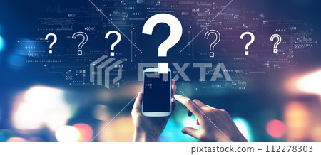 Question marks with a smartphone in city lights at night 112278303