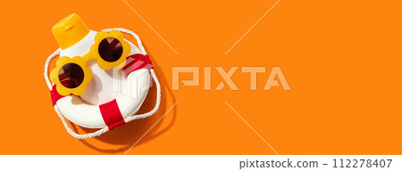 Sunblock bottle wearing sunglasses and a buoy 112278407