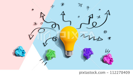 Brainstorming concept with a idea light bulb and crumpled paper 112278409