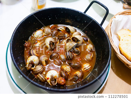 Picture of tasty baked in sauce snails in pan Picture of tasty baked in sauce snails in pan 112278501