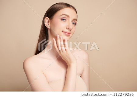 Beautiful young woman with clean fresh skin on beige background, Face care, Facial treatment, Cosmetology, beauty and spa, women portrait. 112279286