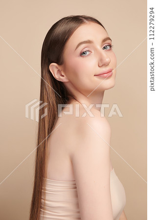 Beautiful young woman with clean fresh skin on beige background, Face care, Facial treatment, Cosmetology, beauty and spa, women portrait. Beautiful young woman with clean fresh skin on beige background, Face care, Facial treatment, Cosmetology, beauty and spa, women portrait. 112279294