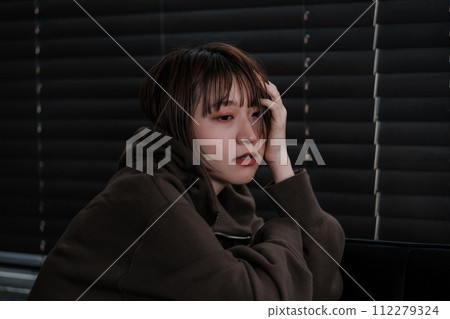 depressed woman in a dark room depressed woman in a dark room 112279324