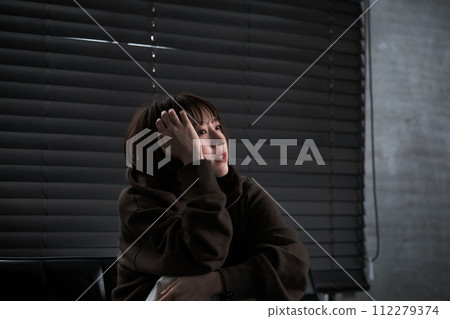depressed woman in a dark room 112279374