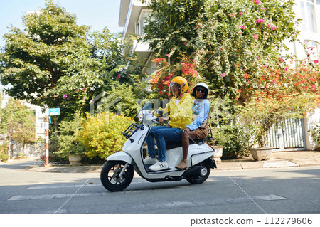 Woman riding motorbike taxi to get around town 112279606