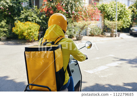 Delivery man with big bag riding motorbike, view from back Delivery man with big bag riding motorbike, view from back 112279685