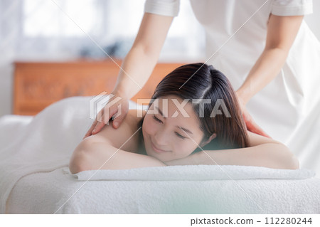 Young woman and esthetician receiving a massage Young woman and esthetician receiving a massage 112280244