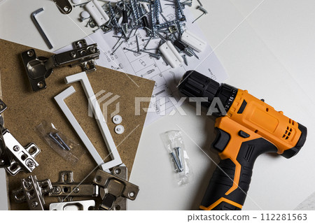 Furniture fittings. Furniture assembly hardware options and tools on a white background. Furniture fittings. Furniture assembly hardware options and tools on a white background. 112281563