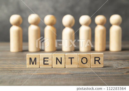 The row of wooden cubes with 'mentor' text and a wooden peg doll The row of wooden cubes with 'mentor' text and a wooden peg doll 112283364