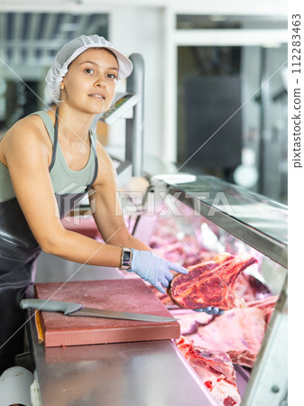 woman behind counter showcases 112283463