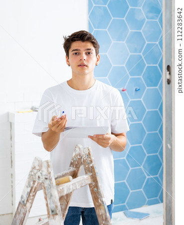 Interested guy making notes while planning house overhaul 112283642