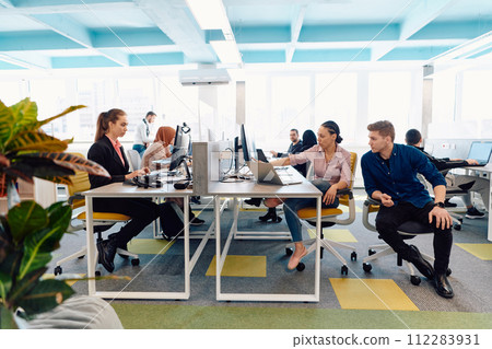 Collaborative process of multicultural skilled young business team during brainstorming meeting in office.Diverse group of young people dressed in formal wear cooperating on developing design project 112283931