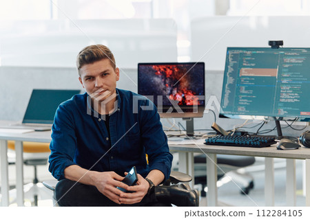 Programming. Man Working On Computer In IT Office, Sitting At Desk Writing Codes. Programmer Typing Data Code, Working On Project In Software Development Company 112284105