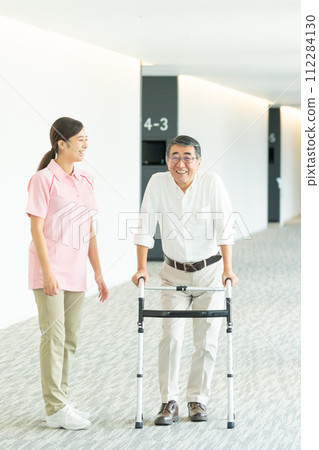 Young women and seniors working at a nursing home 112284130