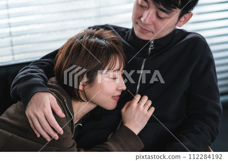Cohabiting couple relaxing on the sofa Cohabiting couple relaxing on the sofa 112284192