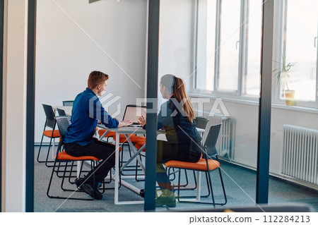 A business leader in a suit conversing with her worker in the IT industry about new business projects and existing business problems A business leader in a suit conversing with her worker in the IT industry about new business projects and existing business problems 112284213