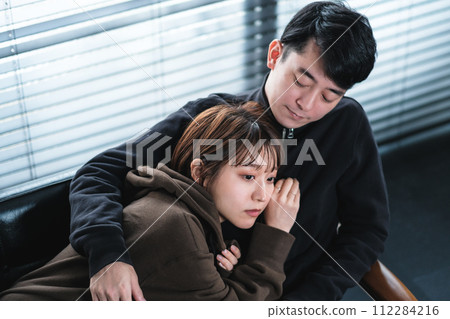 Cohabiting couple relaxing on the sofa Cohabiting couple relaxing on the sofa 112284216