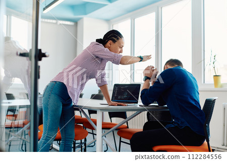 A furious business director of a startup office berating her employee for business mistakes and errors A furious business director of a startup office berating her employee for business mistakes and errors 112284556