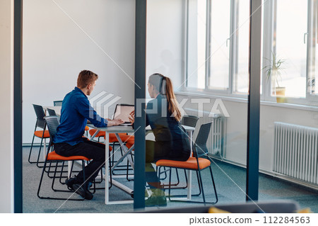A business leader in a suit conversing with her worker in the IT industry about new business projects and existing business problems A business leader in a suit conversing with her worker in the IT industry about new business projects and existing business problems 112284563