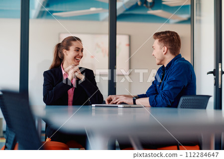 A business leader in a suit conversing with her worker in the IT industry about new business projects and existing business problems 112284647