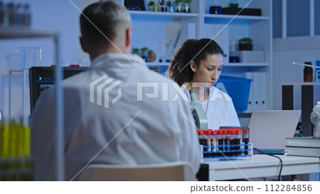 Genetic lab scientist studying health test results, disease diagnostics, medicine development 112284856