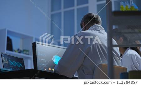 Scientists using modern computer technology for mri diagnostics in clinical lab 112284857