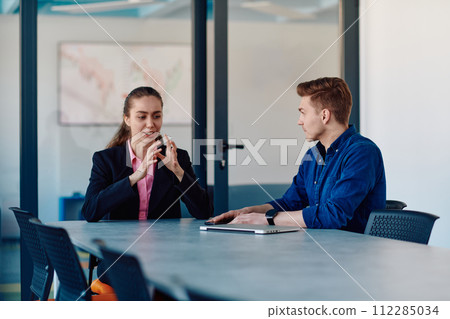 A business leader in a suit conversing with her worker in the IT industry about new business projects and existing business problems A business leader in a suit conversing with her worker in the IT industry about new business projects and existing business problems 112285034