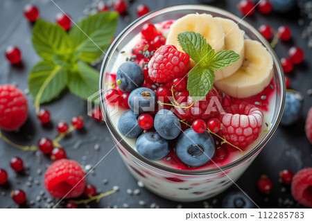 Yogurt with fruits - blueberries, red currants, raspberries, kiwi, banana, physalis 112285783