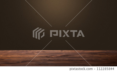 An empty wooden table with brown wall background 112285844