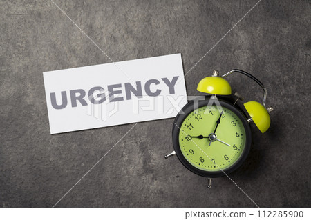 Alarm clock with urgency text on the paper 112285900