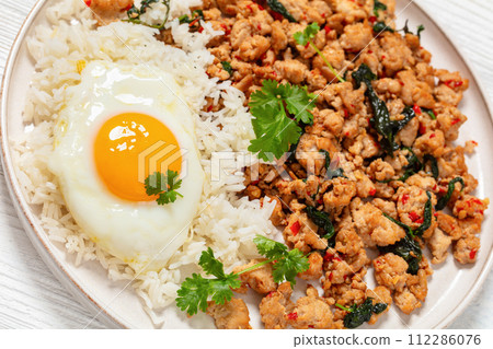basil chicken stir fry with rice and fried egg basil chicken stir fry with rice and fried egg 112286076